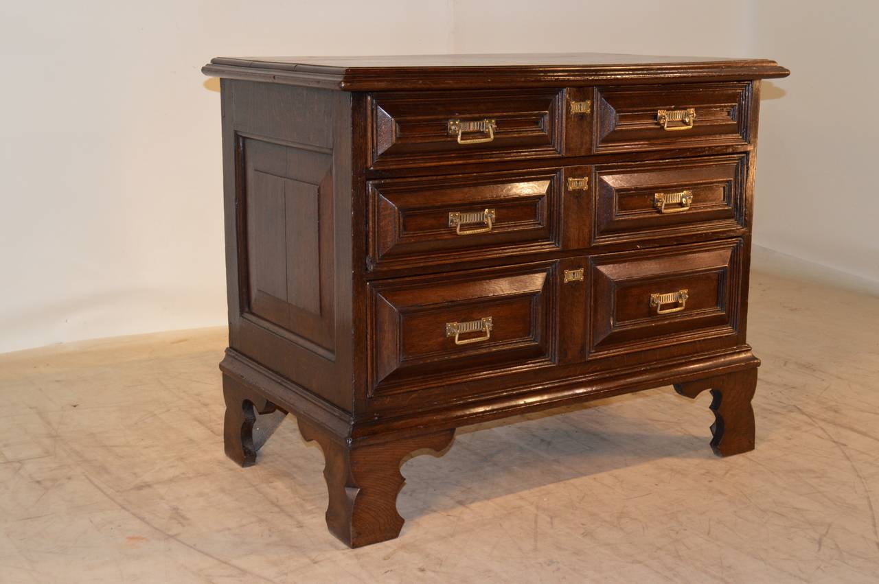 Early 18th century English oak small chest of drawers. The top has a wonderfully molded edge and follows down to raised paneled sides and three drawers. The case is raised upon the most wonderfully detailed bracket feet we have ever seen.