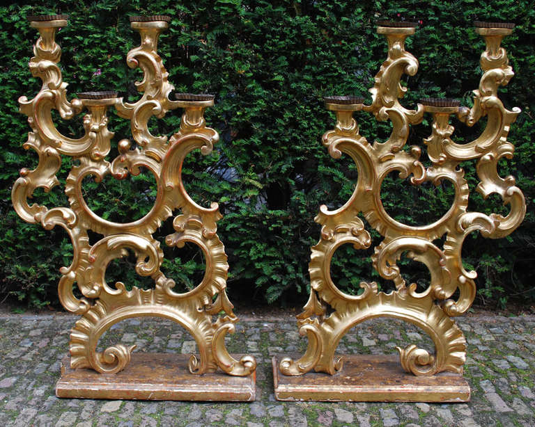 Early 19th century pair of gold gilded wood candleholders.
 Originated in Italy, dating, circa 1820.