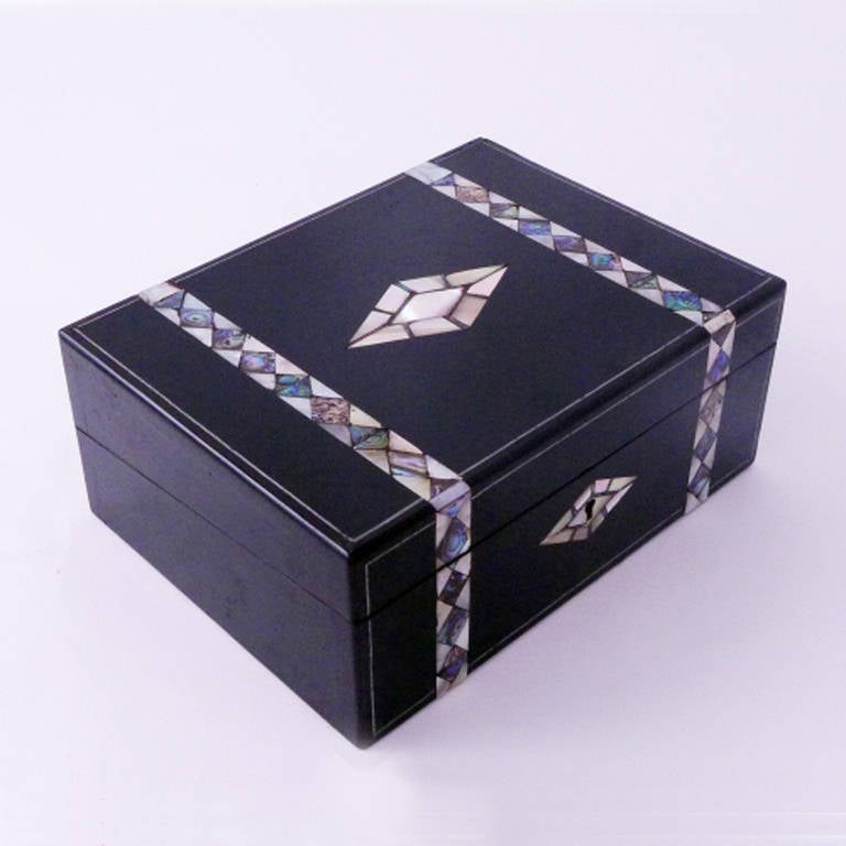 19th century mother of pearl inlay writing box with black leather desk top, original key and several (secret) storage compartments.
Originates England, dating circa 1880.