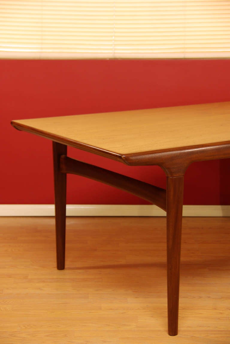 Danish teak dining table with one extension draw leaf underneath the main table surface that pull out from one end of the table. Can expand up to 95.5