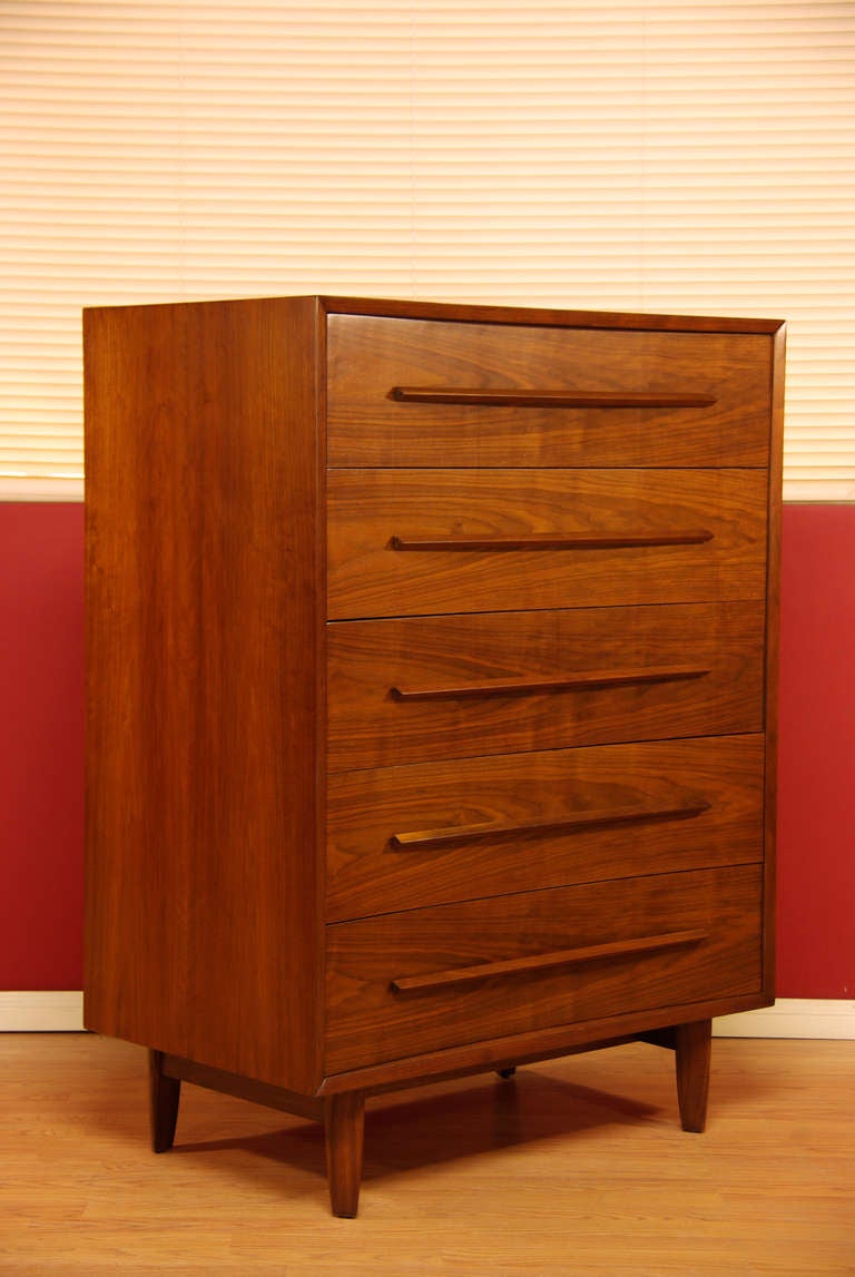 Beautiful walnut chest of drawers designed by TH Robsjohn - Gibbings for Widdicomb. Features sculptural wood handles and concave drawers.