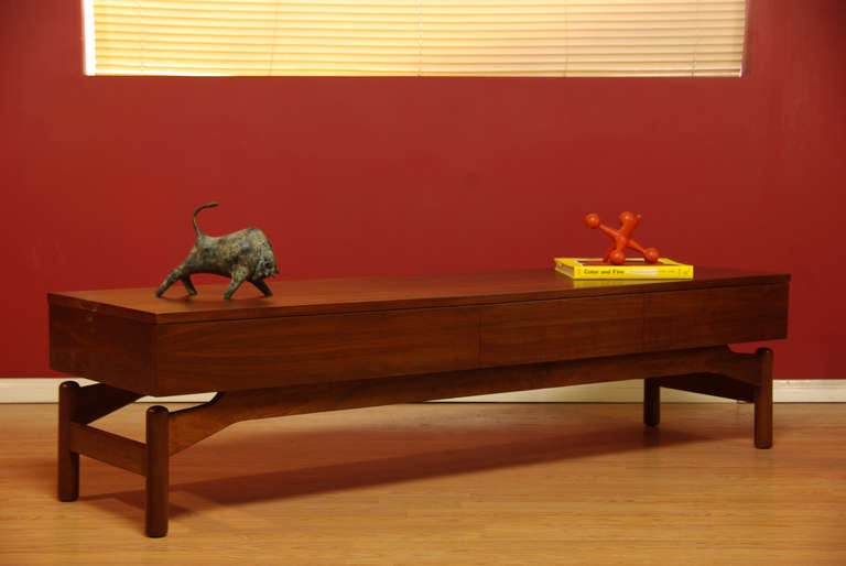 Vintage walnut coffee table designed by architect Greta M. Grossman for Glenn of California. Features a floating top with 3 spacious drawers and finished on all sides.