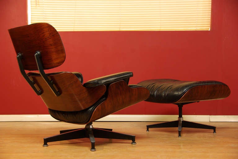 Leather lounge chair designed by Charles Eames for Herman Miller. Constructed of rosewood with leather cushions.