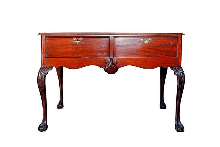 An irish Mahogamy writing table that could also work as a buffet.
With an inset leather-lined top above two drawers on cabriole legs and clawand ball feet.