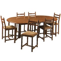  A french Brown painted faux bamboo dining suite by Maison Jansen