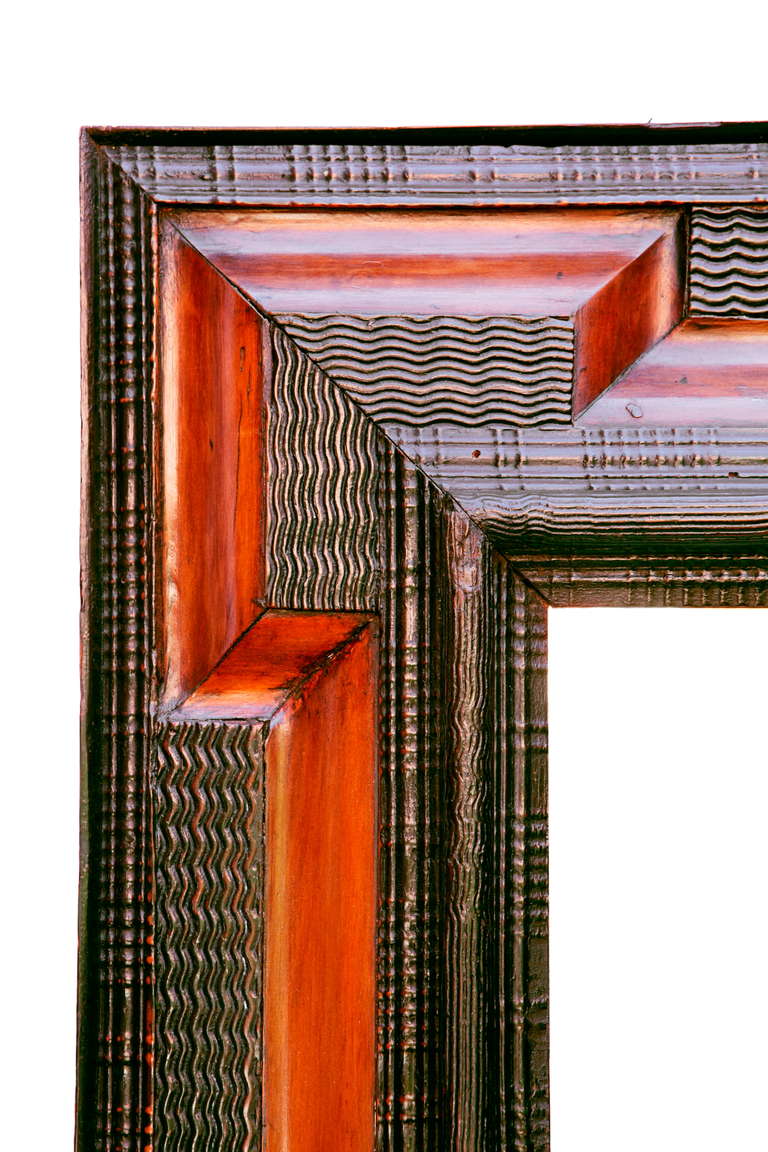 A North European Ebonised and Fruitwood Mirror