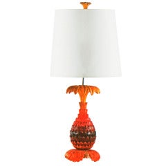 A red-painted pineapple table lamp by Maison Jansen