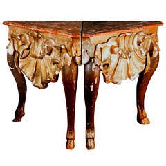 A set of four italian giltwood and marbelized corner consoles