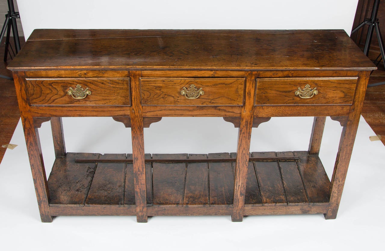 A most charming three drawer oak potboard dresser base of particular good proportions.