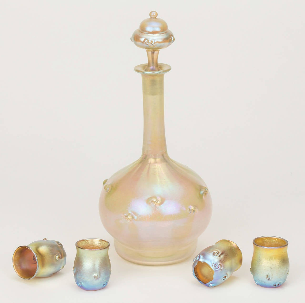 A beautiful Tiffany Studios Favrile Glass Decanter and cordial set. This set comes from an estate in Santa Barbara, California. The original owner purchased in the 1930s. Each piece is numbered. Decanter is initialled and etched LCT U5676. Cordials