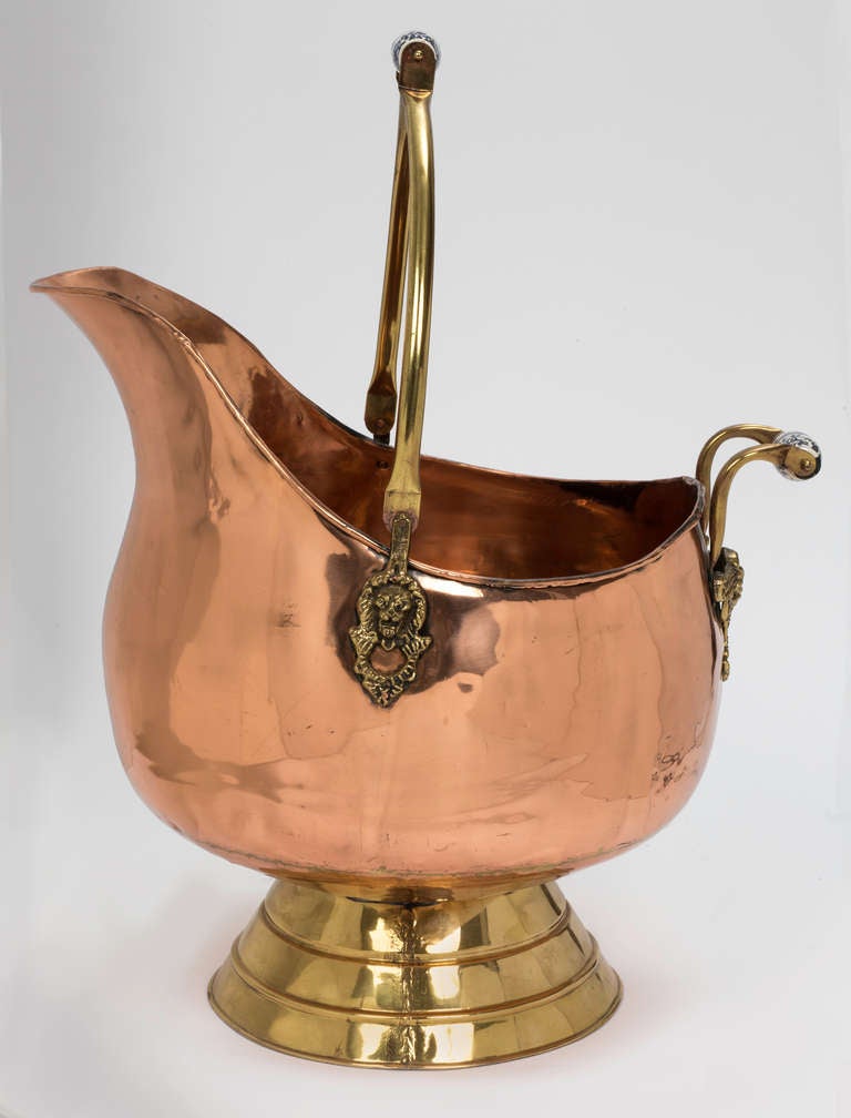 Large and decorative French coal scuttle, useful for wood next to fireplace.  Or great for magazines.  Even great for plants.
Beautiful Shiny copper, with brass base and handle.