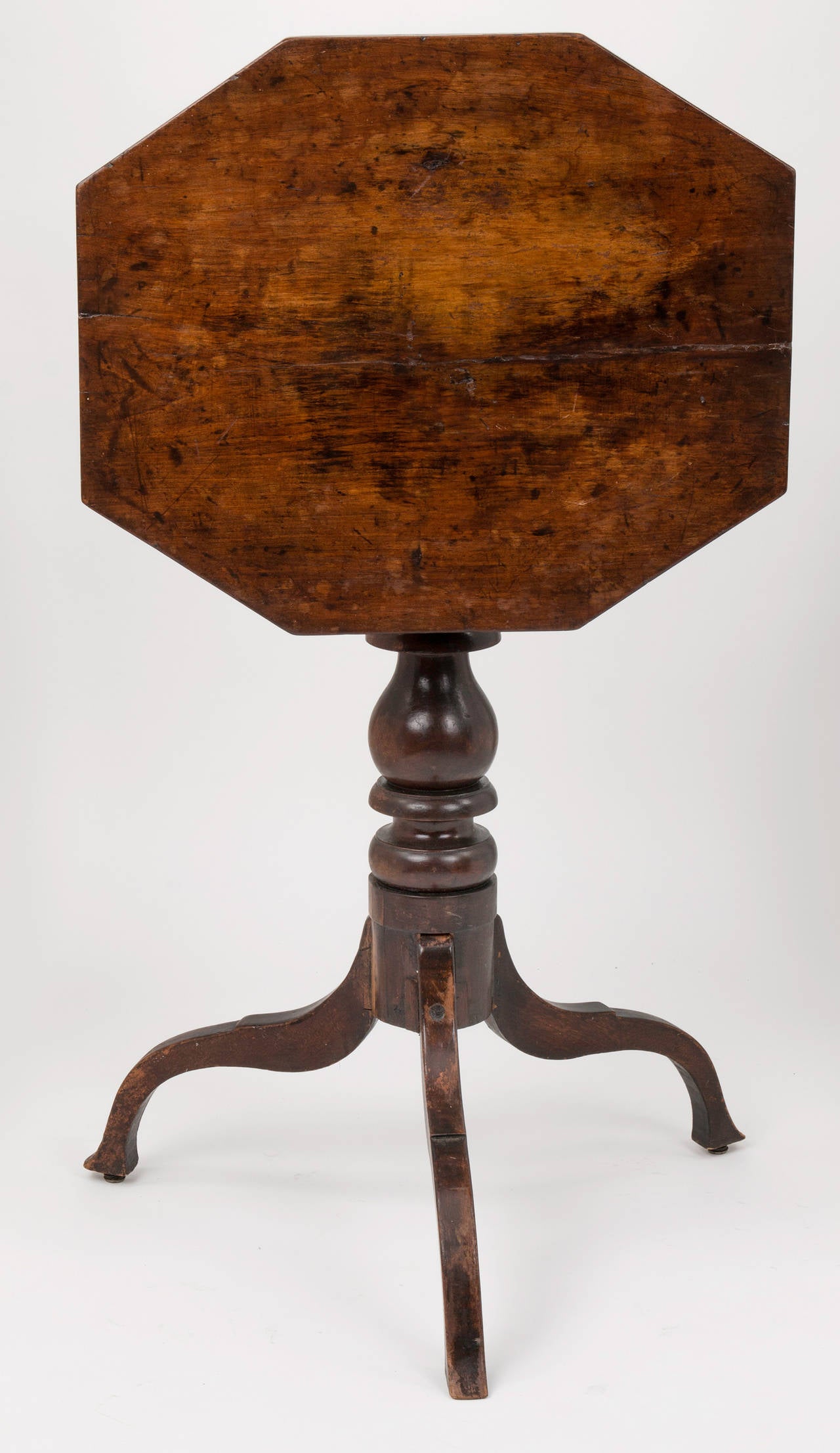 Charming little octagon  shape tilt top table.  Nicely turned pedestal with simple curved  tripod lega.  19c table nicely aged with latch underneath later replaced.  Height is 38