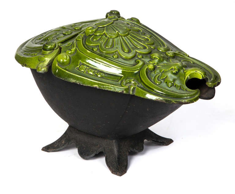 19th century coal scuttle in beautiful bright green enamel over iron.
Unusual shape and color with hinged lid. It would also make a very decorative ice bucket or wine cooler. Great look on a bar counter.