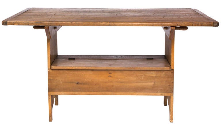 C. 1860s Wonderful warm primitive pine table.  Remove two pegs, flips up to turn into a bench with storage inside the bench.  Very handy versatile use.