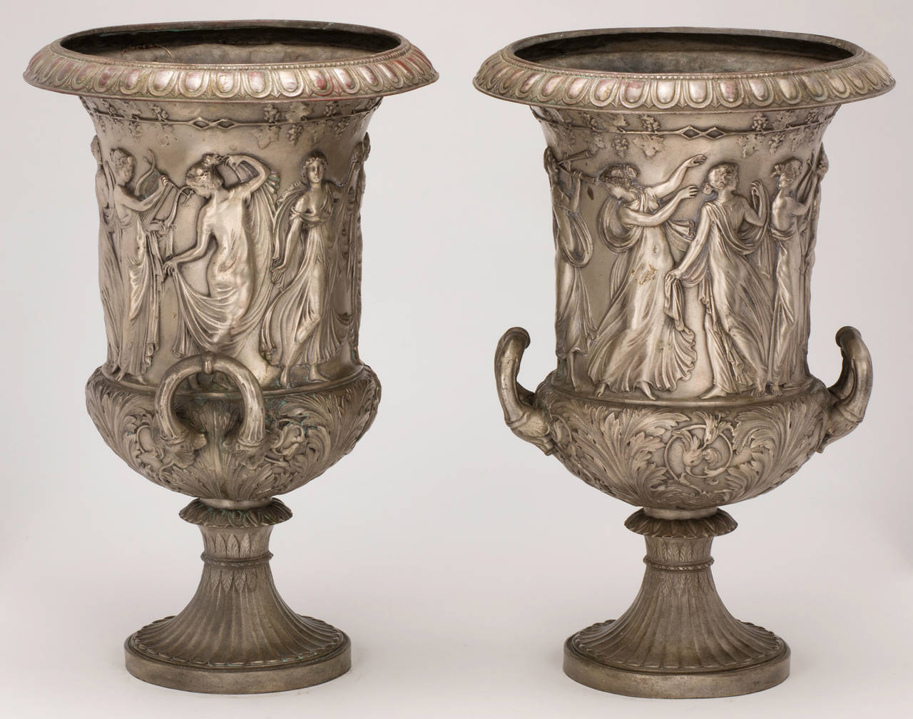 Fantastic pair of Italian patinated pewter bronze urns. Wonderful relief processions of drama, music and dance. Handles on each side, decorated with acanthus motifs. Solid bronze.