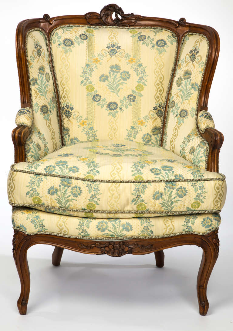 Late 1800s, Louis XV style.  Very comfortable French Tub chair.  Beautifully detailed carved walnut frame. Newly upholstered in French blue silk brocade.  Down seat cushion.