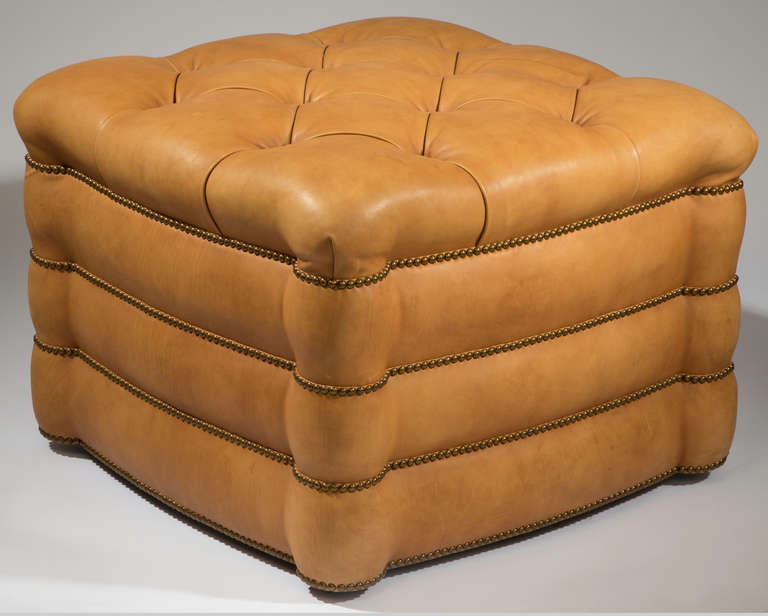 C. 1990s.Wonderful and practical custom made ottoman in mellowed  camel color leather.  Beautifully tufted and finished in antique brass nail studs.
Great as coffee table with tray.  In excellent condition.