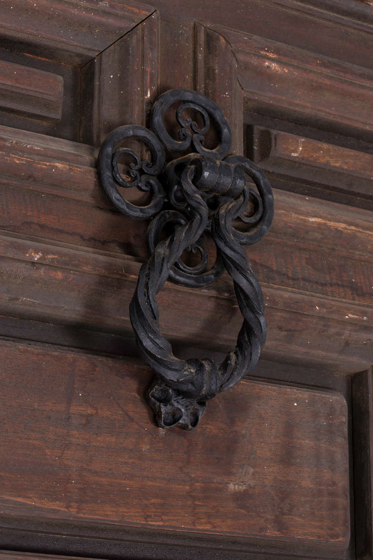 Late 1800s . Massive California Spanish  panel door with original iron knocker hardware, iron peek grill and iron hinges.  Door handle is brass, added later. This door comes from Rancho Techolete, one of the original large ranch belonging to Doheny