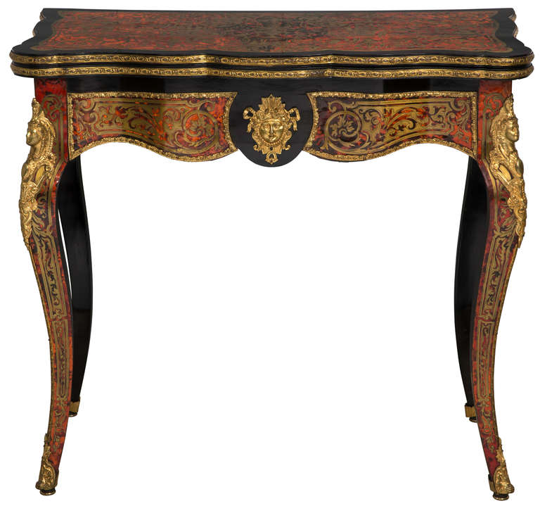 Beautifully made Boulle  table by the finest furniture jeweler of Paris in the mid 1800s.  Dyed tortoise shell inlaid and dore bronze on lacquer finish.  Rotating top to conceal a game table.  Rare to find Boulle game table with interior  Boulle