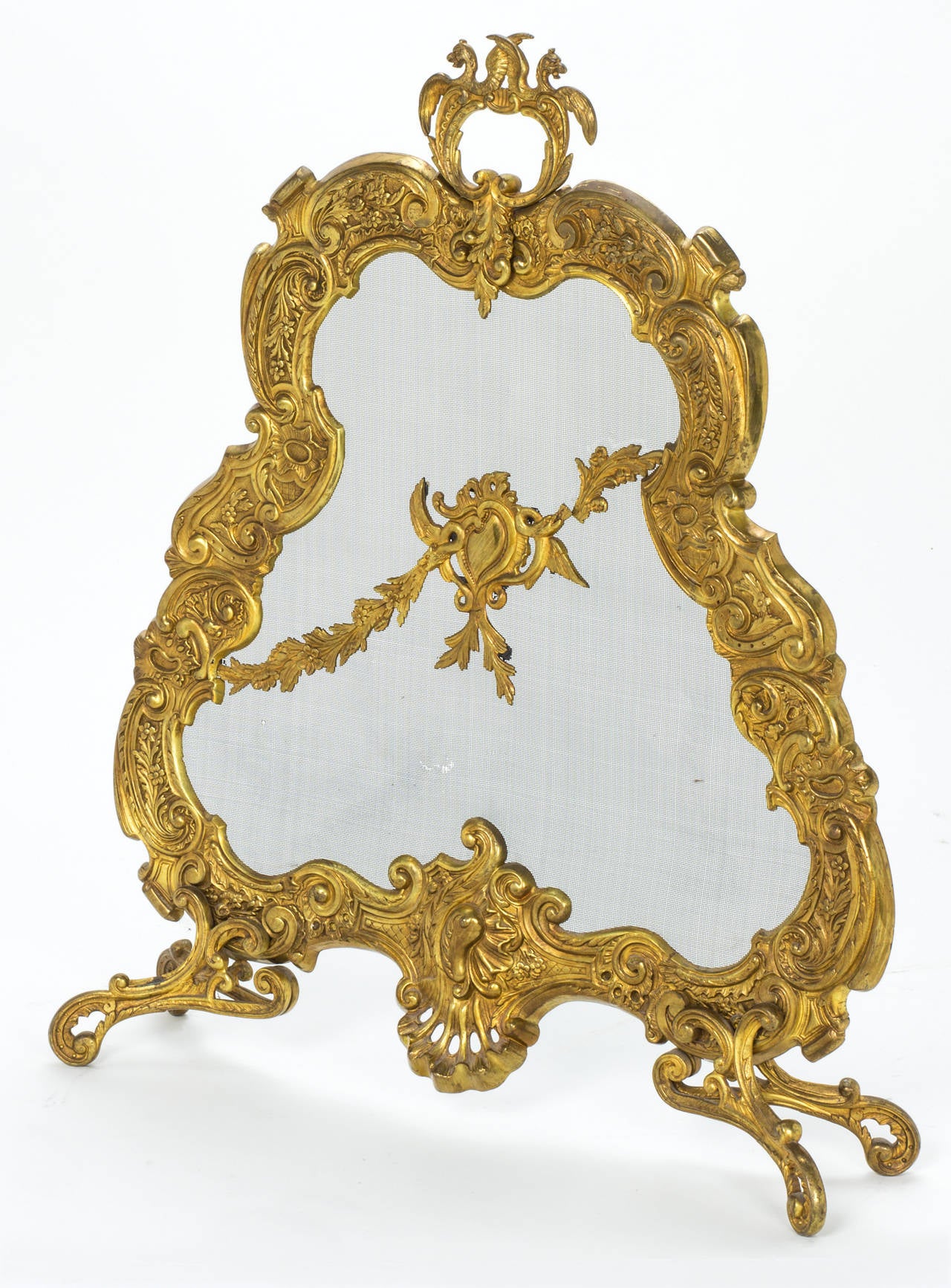 C. 1860s French gilt bronze fire screen.   Wonderful cast workmanship of flowing floral motif with small winged dragons at the top for handle. There is a small tear in the lower center part of the screen, which does not detract from the quality of