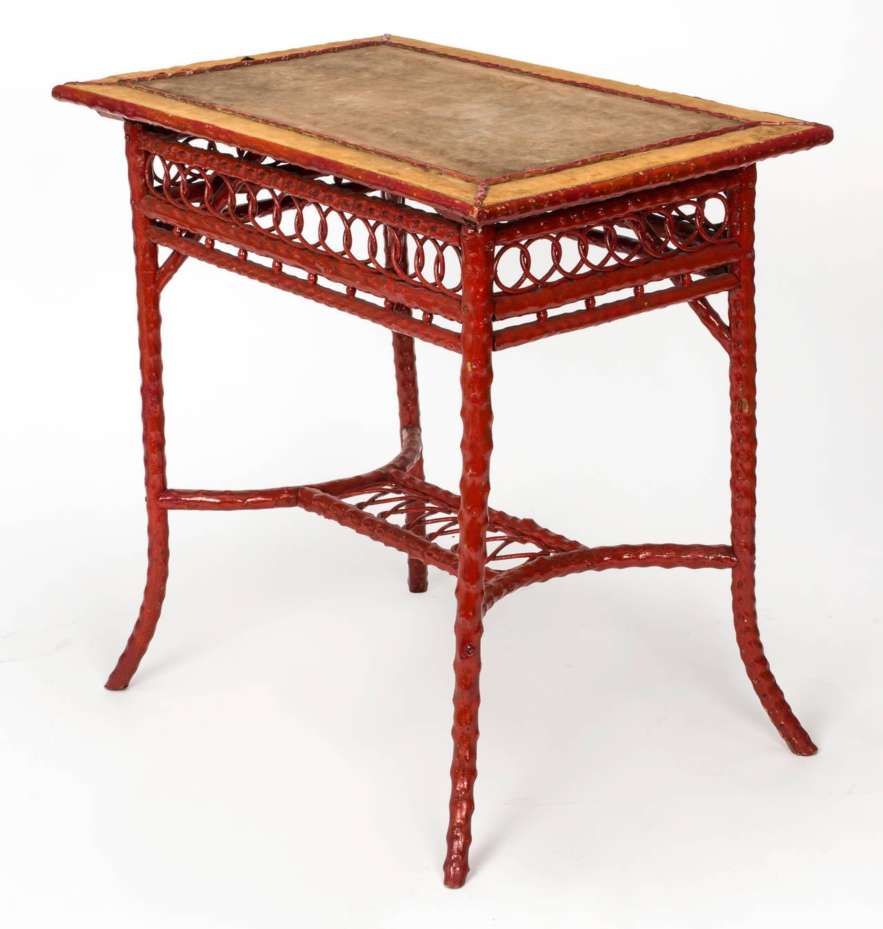 From mid-1800s, English bamboo table painted in red lacquer to look like the Chinese red Cinnabar. 
Original velvet covering on top. Lovely accent table. Useful as a desk or bedside table. Matching chairs and other pieces can be seen on this site