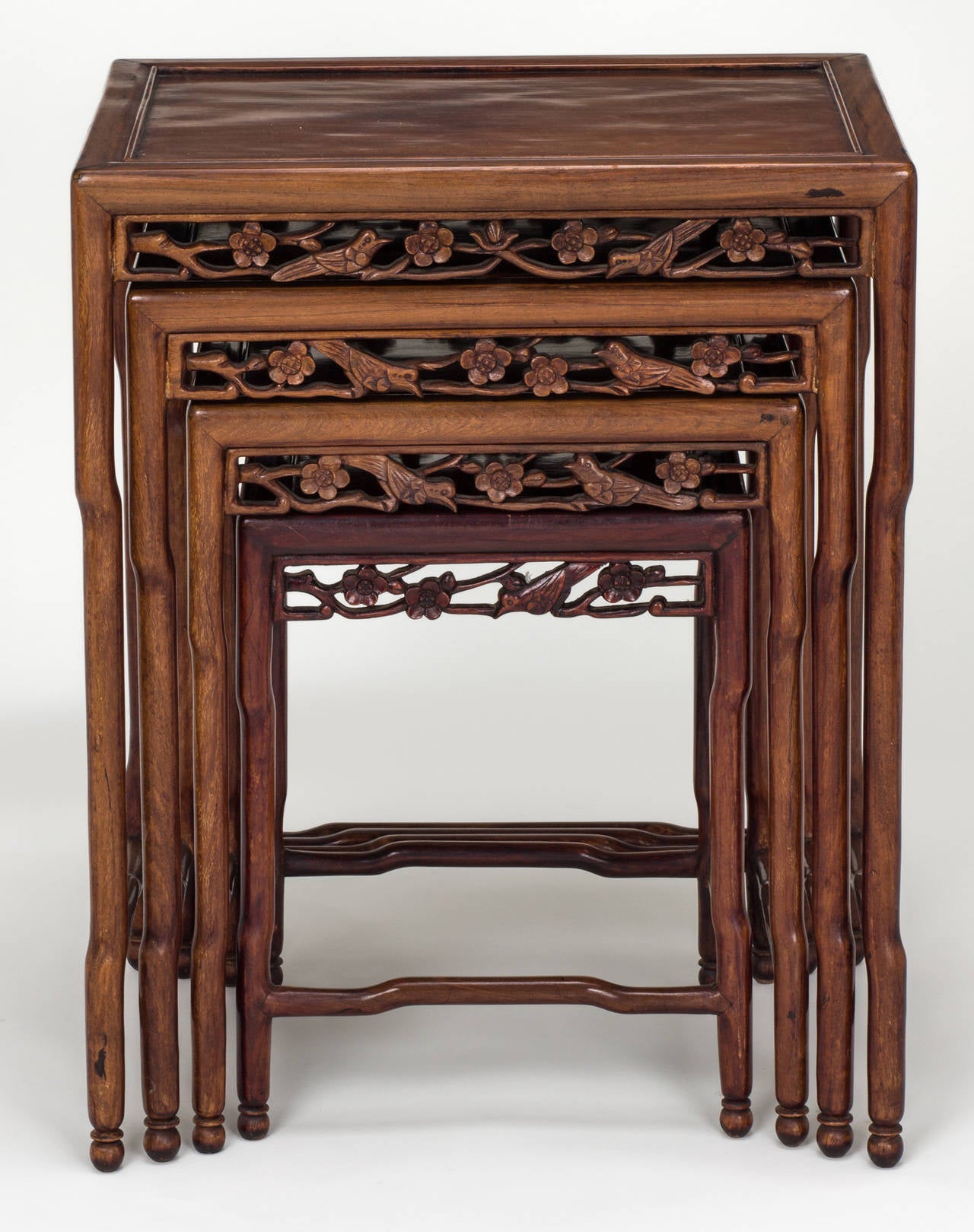 Lovely set of four Rosewood Chinese nesting tables from 1940s.  
Each table is nicely detailed.  Delicately carved apron front with cherry blossoms and birds.
List of dimensions:
1st (Largest) table = 14D x 19W x 24.5h
2nd table = 12.75D x 16.5W