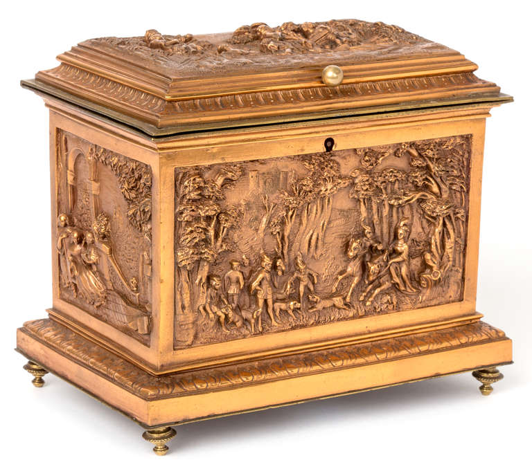 Rare, hard to find copper and brass  casket.   Beautiful reliefs of pastoral and hunting scenes on all four sides.  Interior is lined in tufted blue silk.