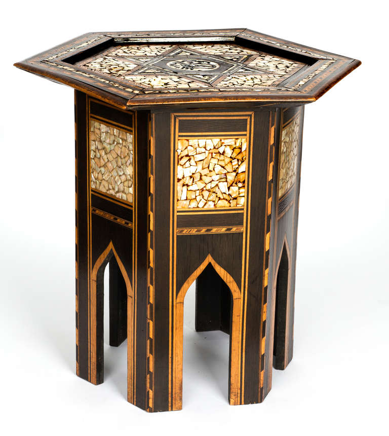 Six sided Moroccan pedestal decorative side table.  Beautiful inlay  of mother of pearl and wood marquetry.   A few pieces of the mother of pearl and inlay wood are missing, but does not detract from the overall beauty of the table.
