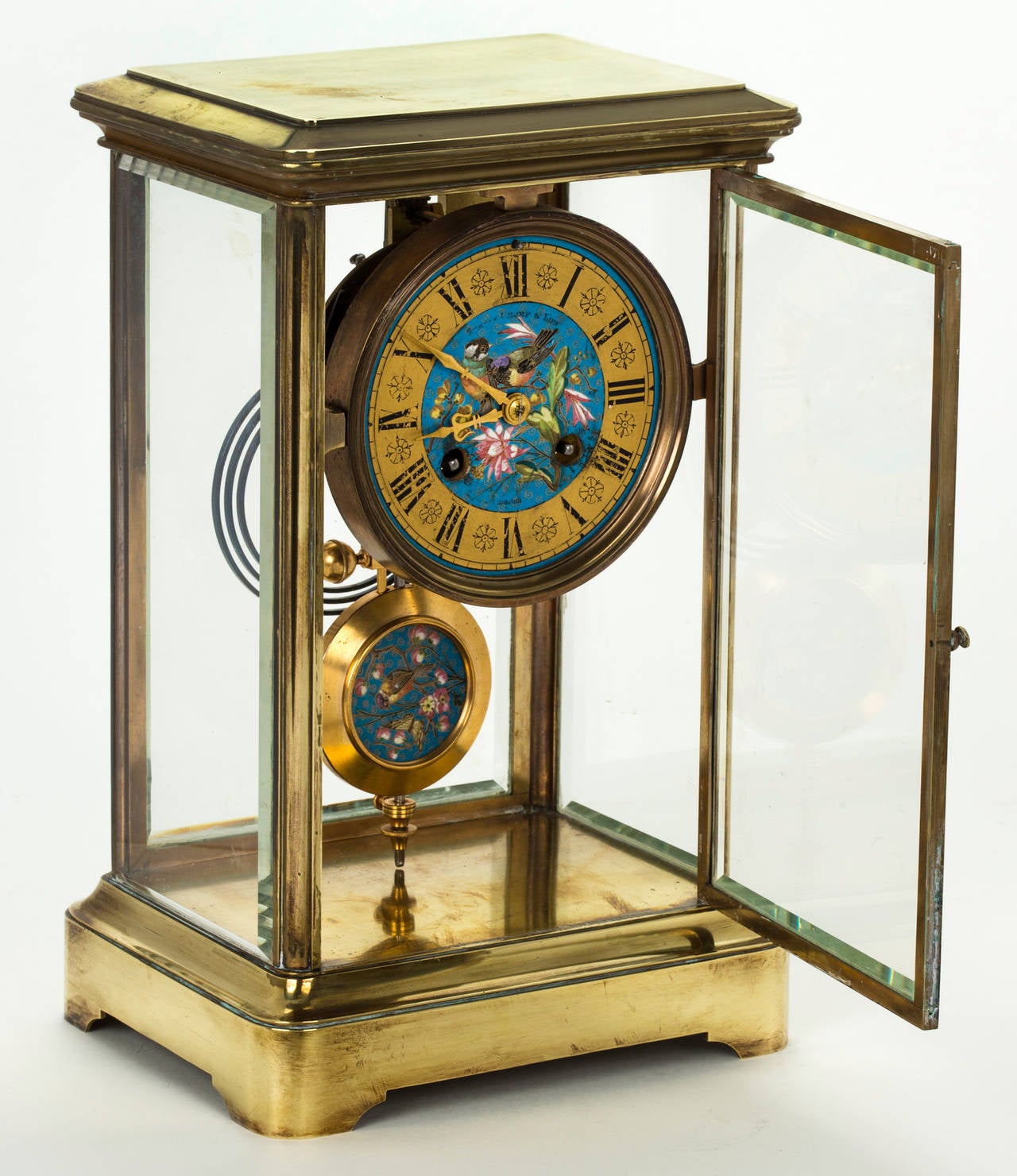 Lovely French table clock.  Beautifully enamel painted face and pendulum.  8 day regulator with key.  Heavy brass with bevel crystal panels on all four sides.  Recently cleaned in excellent condition.