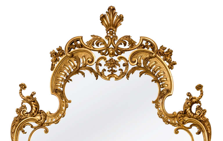 Beautiful and delicately  carved, yet stately.  Great Entry mirror.
C. 1880s, 24k gilt mirror.  The carvings are superbly done.
Mirror glass itself  are in three sections as the originals were.