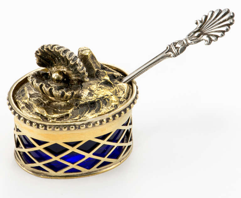 N small cobalt lined sterling salt box, circa 1910. Marked Italy Tiffany & Company warm gold wash overall.
Lid is solid silver of cast oyster with pearl. Spoon is as found, not Tiffany, but sterling. It is included. 2.5 long.