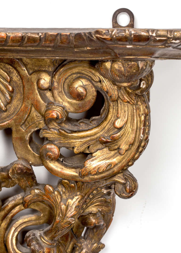 C. 1740s Exquisitely detailed Hand Carved Wall shelf.  Gilt wood carvings of a male face surrounded by acanthus foliage.  In excellent condition.  From an estate of a museum curator.