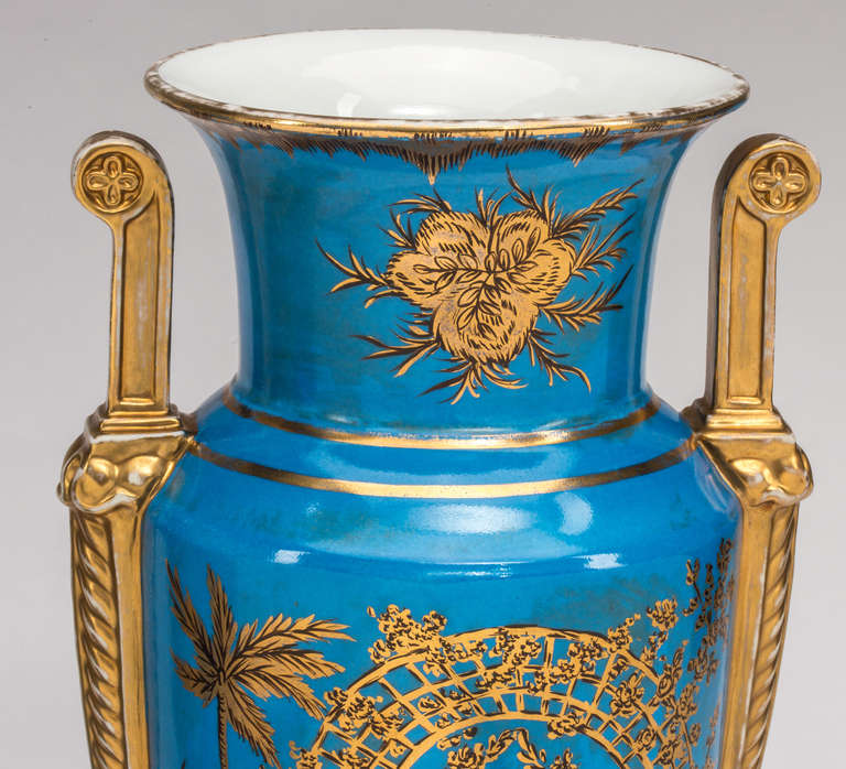 Highly decorative  pair of striking French blue and gilt Chinoiserie style urns.  Each urn depicts figures in fashionable attire.  Handles on each sides over the shoulders of wide mouth.  These will also make  stunning pair of lamps.
