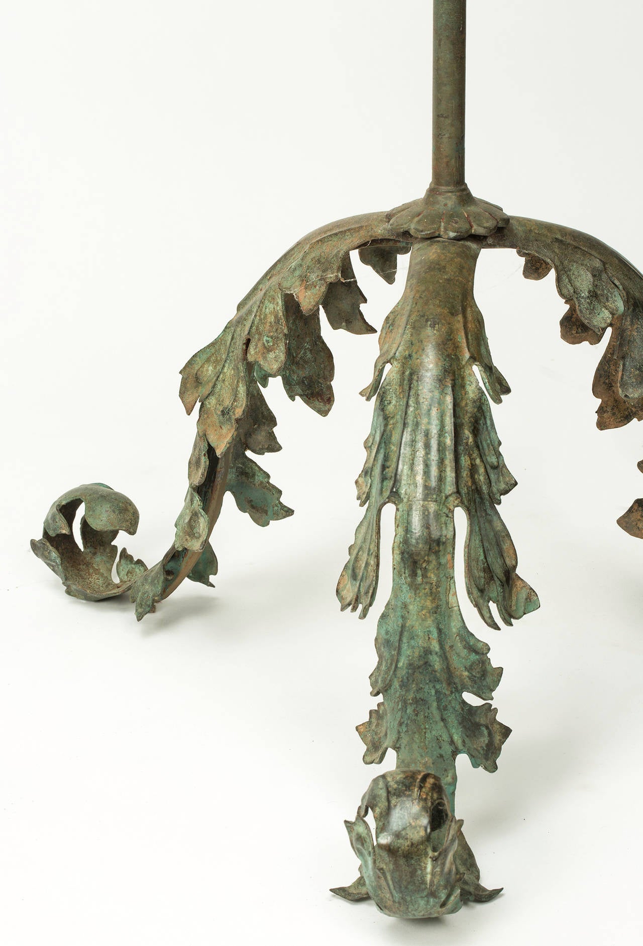 Dramatic pair of floor lamps.  Base support is tripod acanthus leaf motif  in cast bronze.  Contrasted to simple elegant posts also in bronze.  Beautifully   Verdigris finish.  Shades not included.