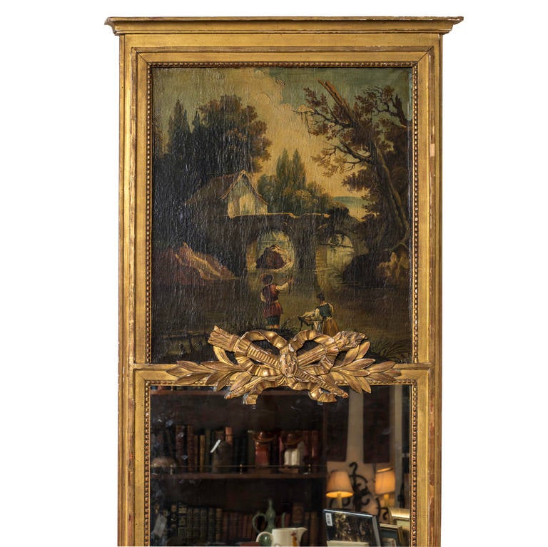 Trumeau with painting on canvas of romantic 19th century bucolic scene.
Vertical mirror framed in carved wood in gilt with garlands of ribbon.
Part of the gilt ribbon tail is missing.  Perfect for vertical need.