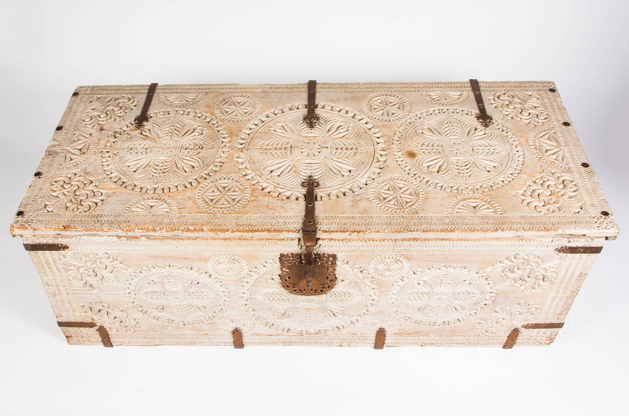 Dramatic Moroccan style, decorative antique trunk.  Bleached white wash finish.
Detailed carved wood, accented with iron straps and lock. Opens and hinged for blanket storage, etc.