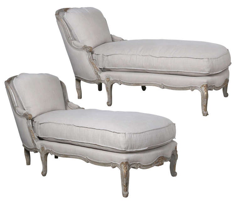 Pair, or single.  C. 1940s French style carved frame.  Beautifully gilded and gressel painted finish.  Fantastically comfortable large scale chaise.  Newly upholstered In fresh gray linen with all down cushion.  Priced individually.
One is sold.