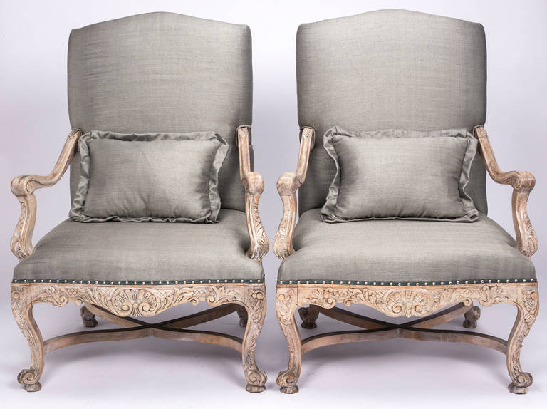 Louis XV style,  Large sumptuous carved arm chairs. Newly upholstered in blue gray silk. Back is upholstered in aqua blue velvet. Finish trim with chrome accent nail studs. Carvings are detailed, light gray bleach wood finish, giving a contemporary