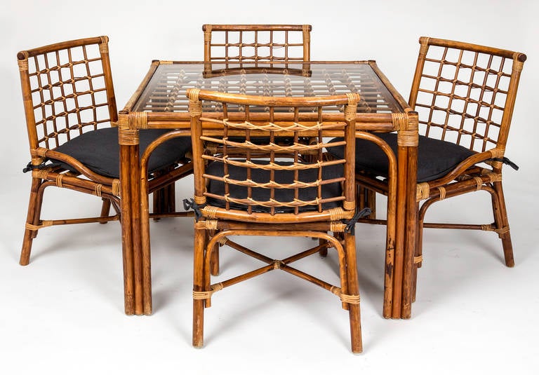 All made of bamboo, Set of four chairs and square table with glass top. Seat cushions in Sunbrella fabric included.  Very sturdy and comfortable.  Great for small dining, or game table set.  The table is 36