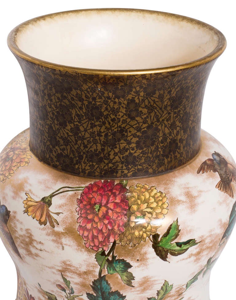 Sitting on a gilt wood plinth, this is a dramatic and monumental  late Satuma style urn.
Bordered base and shoulder neck is brown gilt cherry blossom patterns with center body beautifully painted  in chrysanthemums and flying birds.