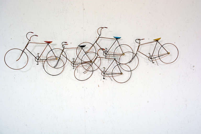 For your consideration a vintage wall sculpture. 
Five bikes with different color seats. Signed on the last bike.