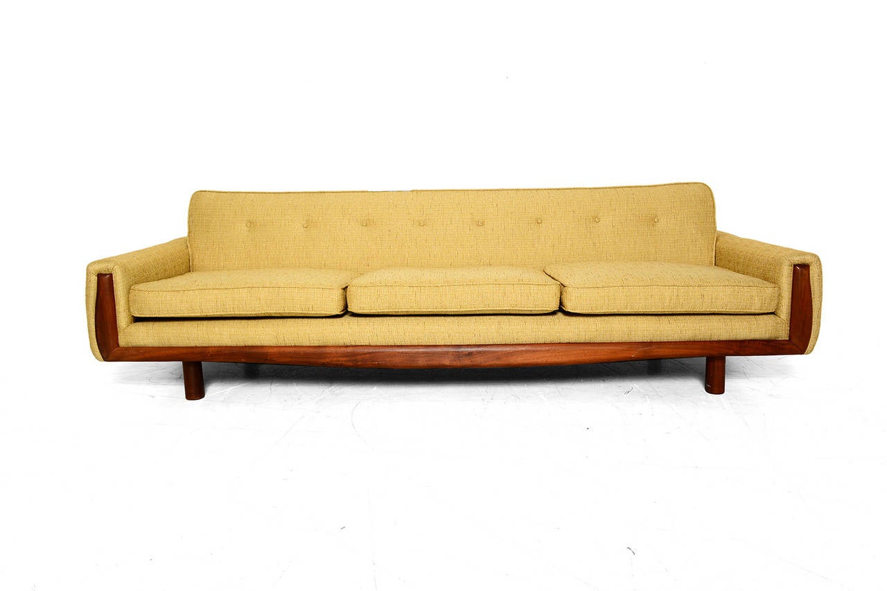 Clean modern lines with three cushions and walnut frame on the front. Solid walnut legs.

New upholstery with yellow color. New fabric with vintage texture.