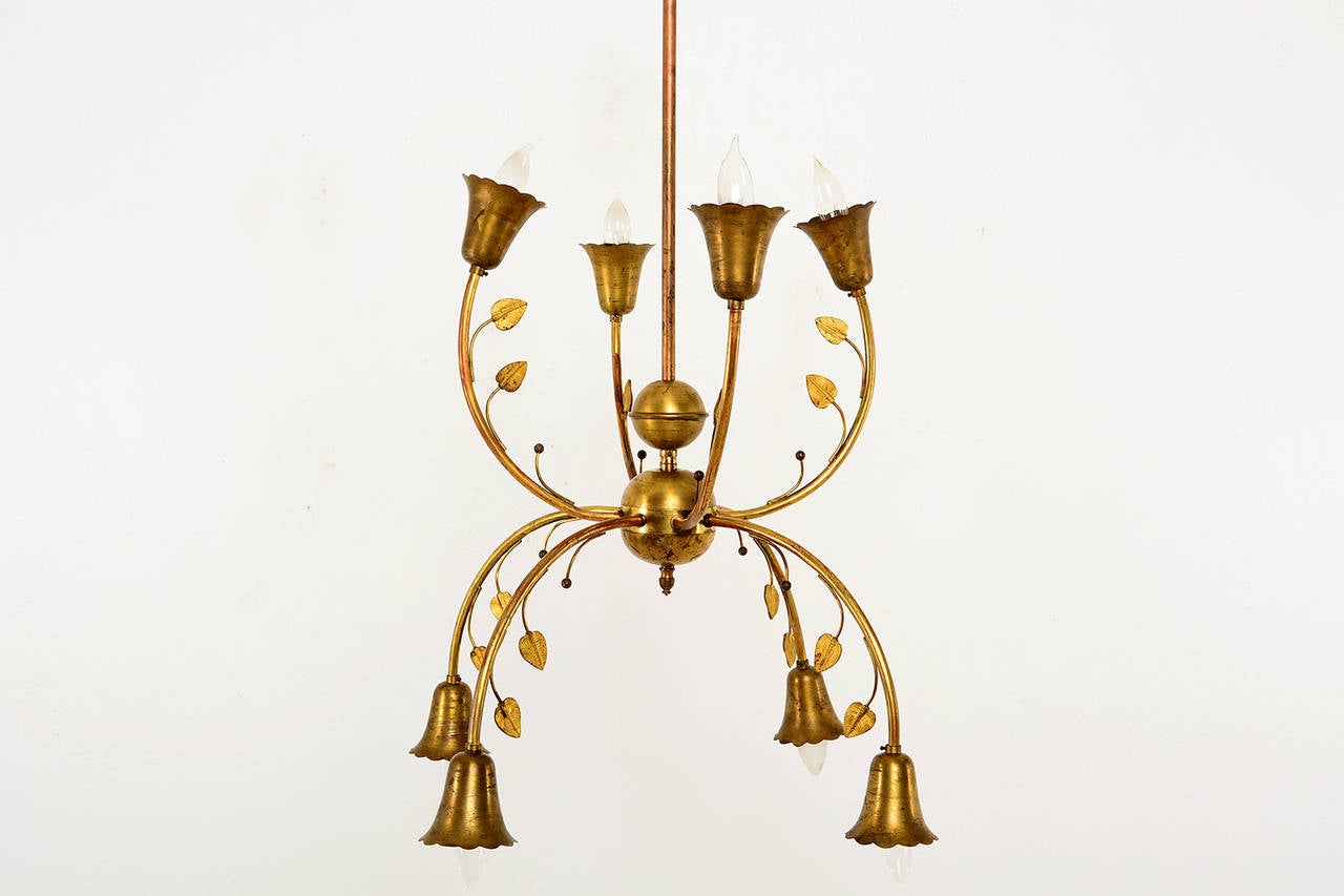 For your consideration a vintage Italian chandelier constructed in solid brass.
The chandelier has the shape of flower bouquet. Four flowers up and four flowers down.

Chandelier is unmarked. No information on the maker.

The rod is 38
