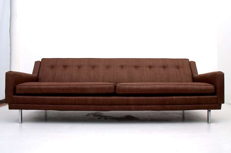 Elegant vintage sofa with clean modern lines. New upholstery in excellent condition. Mounted in chrome plated legs. Attributed in style to MIlo Baughman. Brown upholstery has a satin finish and looks like linen. 