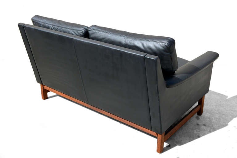 Teak wood with black leather.

Loveseat part of of a living room set
Sofa & Chair.

Feather down cushions.