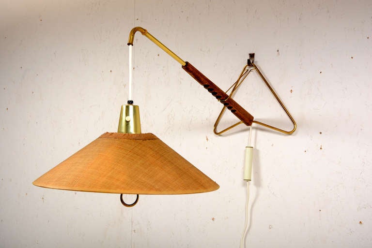 For your consideration a mid-century modern wall sconce with unique hanging system.

The lamp has a new electric wire. A iron counter weight helps keep the lamp on place.  Lamp can be adjusted so different heights and lengths.

Turn on and off