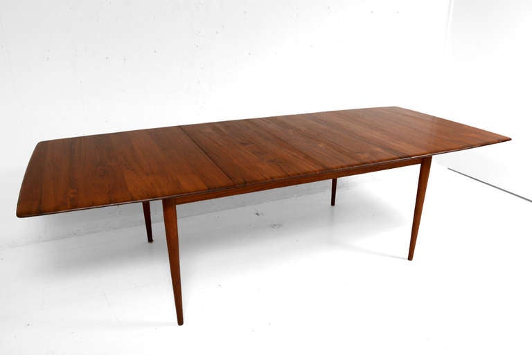 For your consideration a solid teak wood dining table designed by Johannes Aasbjerg. 

Tapered edges with to removable leaves. Leaves can be stored under the table top.

Legs can be removed for safe and easy shipping. 

Each leaf is 18 1/2