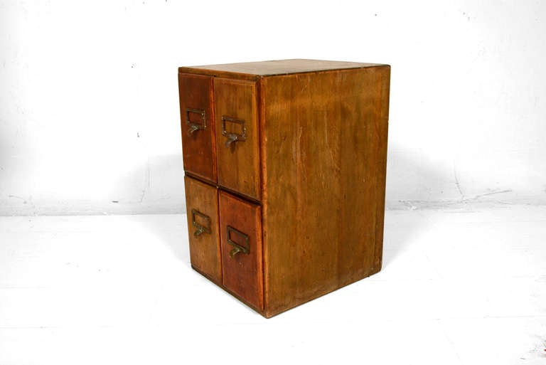 For your consideration a vintage file/card cabinet. Solid wood with exposed dove tail joints. 

Four pull out drawers with solid brass pull handle and window frame to label the contents. 

Original vintage patina. All drawers open and close with