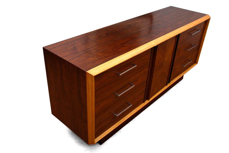 For your consideration a vintage dresser/ credenza produced by LANE. 
Two tone, walnut with lighter tone accent wood. Chrome plated sculptural handles. Six pull out drawers constructed with dove tail joints. They open and close very smoothly.