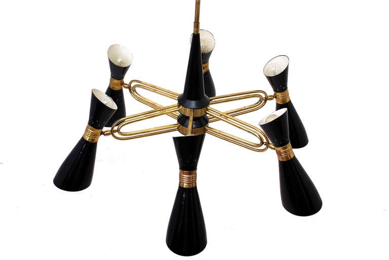 Beautiful italian chandelier attributed to Stylnovo. Six sculptural aluminum shades  with brass hardware and fittings. The shades fits a large bulb on the bottom and small on top. They can be arrange to direct the light in multiple directions.